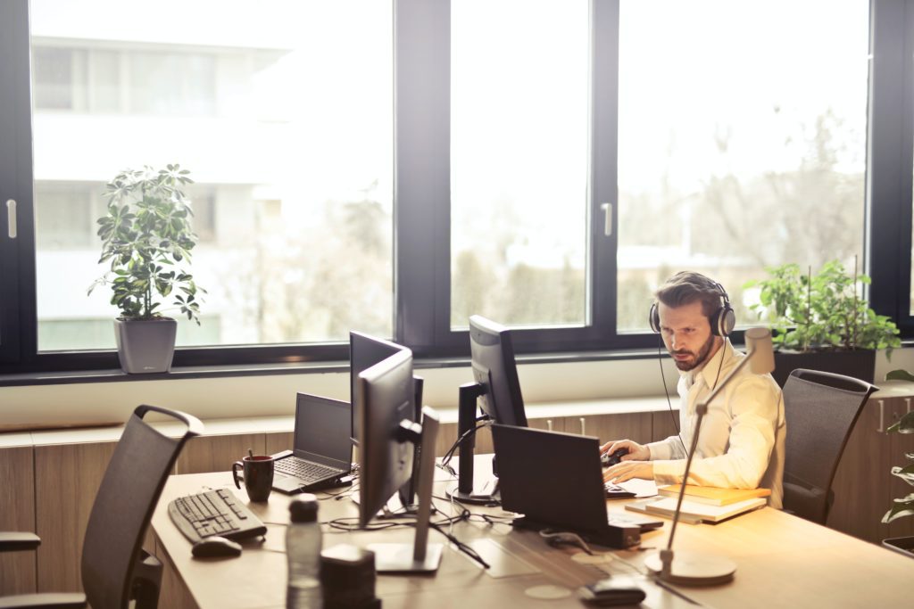 white man in office looking at computer screen